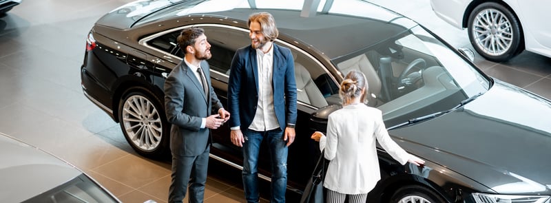 business-couple-with-salesperson-in-the-car-showro-2023-11-27-04-56-12-utc_crop-1