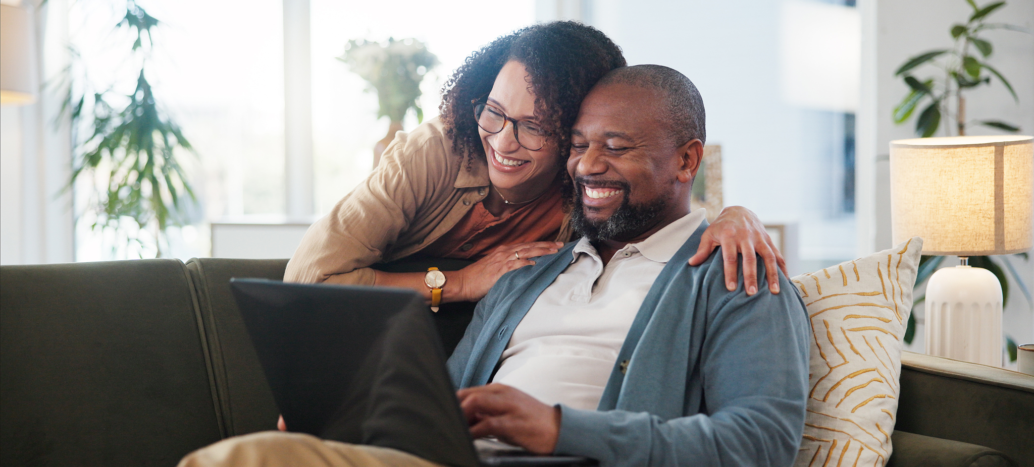 laptop-relax-and-couple-on-sofa-in-home-for-resea-2025-04-06-10-59-03-utc 1