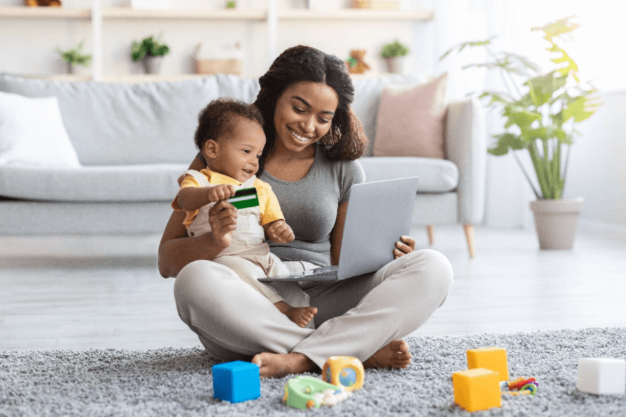 black-mother-with-infant-baby-using-laptop-for-onl-2022-10-07-02-17-34-utc@2x-1